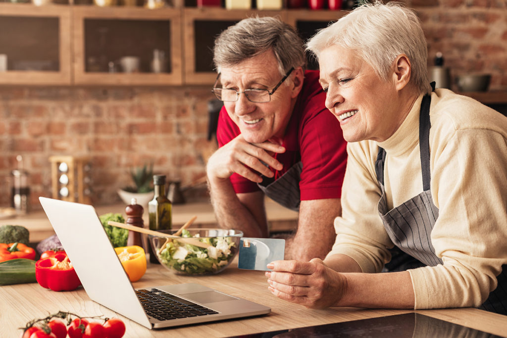 Freshop - eCommerce for Grocery & Specialty Retail Happy seniors ordering Groceries online on laptop and credit card at kitchen Freshop - eCommerce for Grocery & Specialty Retail Happy seniors ordering Groceries online on laptop and credit card at kitchen